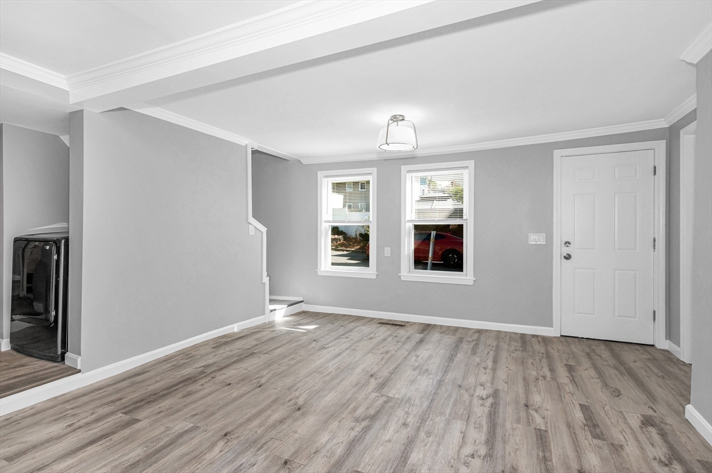 213 Prospect Street Lawrence, MA 01841 - Photo 12 of 33 wooden floor in an empty room with a window