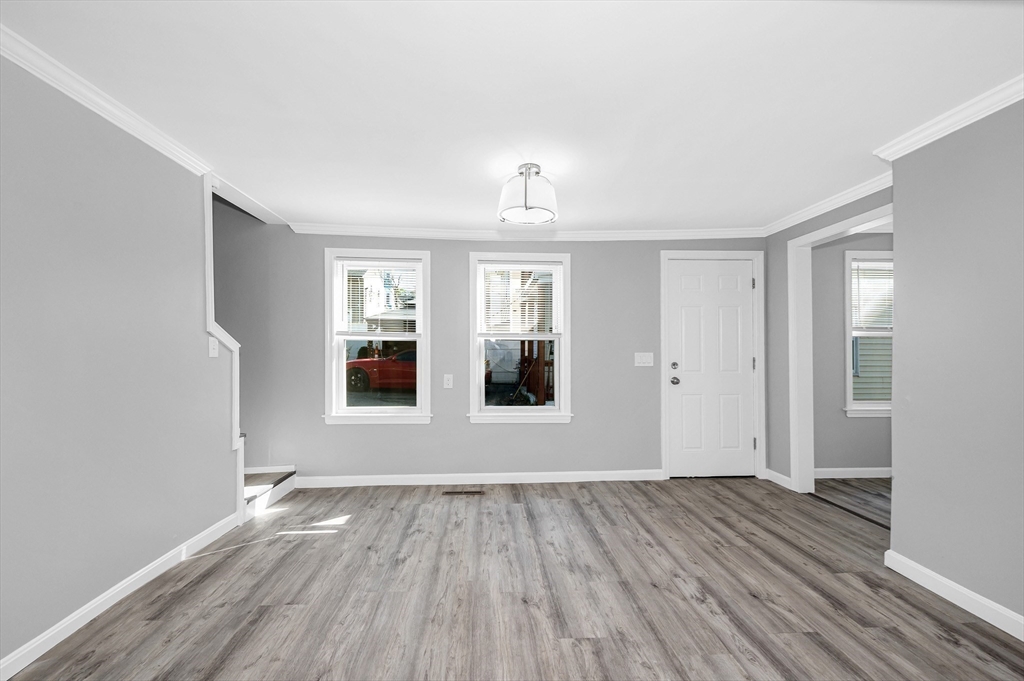 213 Prospect Street Lawrence, MA 01841 - Photo 13 of 33 wooden floor in an empty room with a window