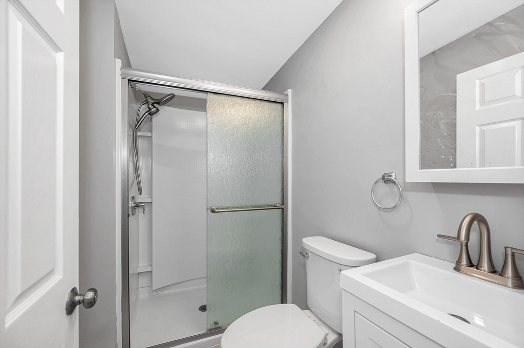 213 Prospect Street Lawrence, MA 01841 - Photo 15 of 33 a bathroom with a toilet sink vanity and shower