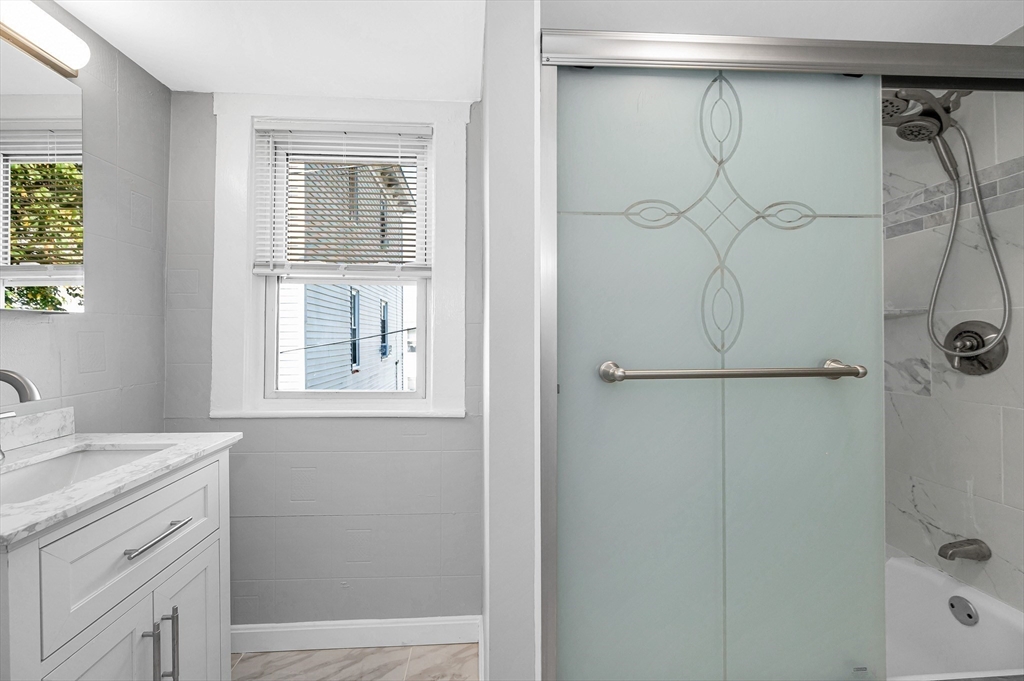 213 Prospect Street Lawrence, MA 01841 - Photo 17 of 33 a bathroom with a shower and a sink