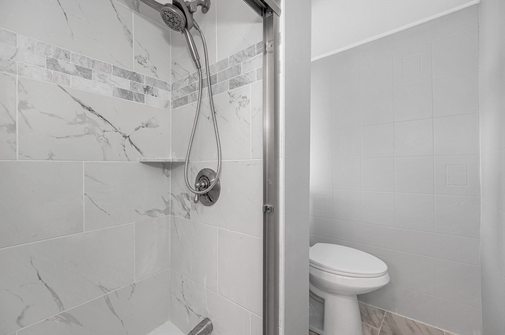 213 Prospect Street Lawrence, MA 01841 - Photo 18 of 33 a bathroom with a toilet and shower