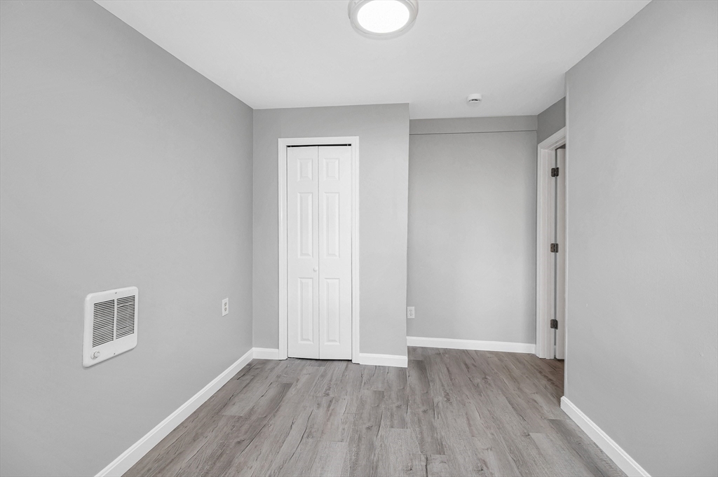 213 Prospect Street Lawrence, MA 01841 - Photo 20 of 33 a view of an empty room with wooden floor
