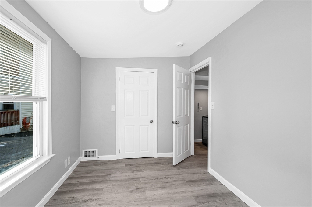 213 Prospect Street Lawrence, MA 01841 - Photo 22 of 33 a view of an empty room with wooden floor and a window