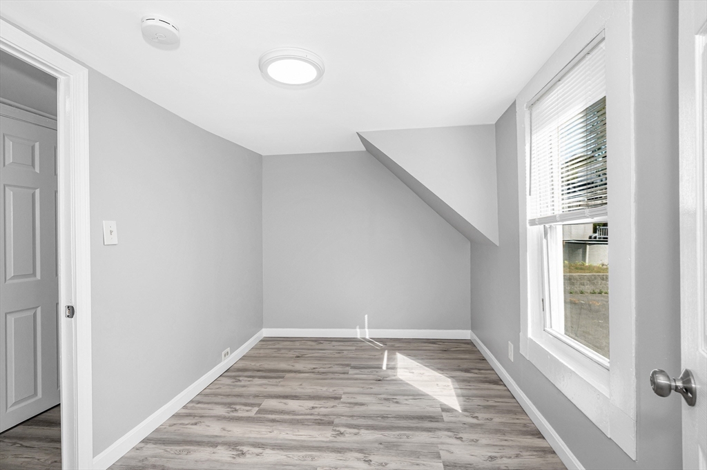 213 Prospect Street Lawrence, MA 01841 - Photo 23 of 33 a view of empty room with wooden floor and fan