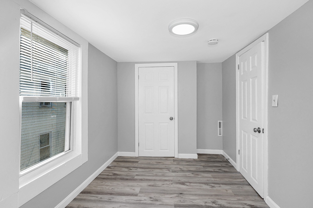 213 Prospect Street Lawrence, MA 01841 - Photo 24 of 33 a view of a livingroom with wooden floor and a window