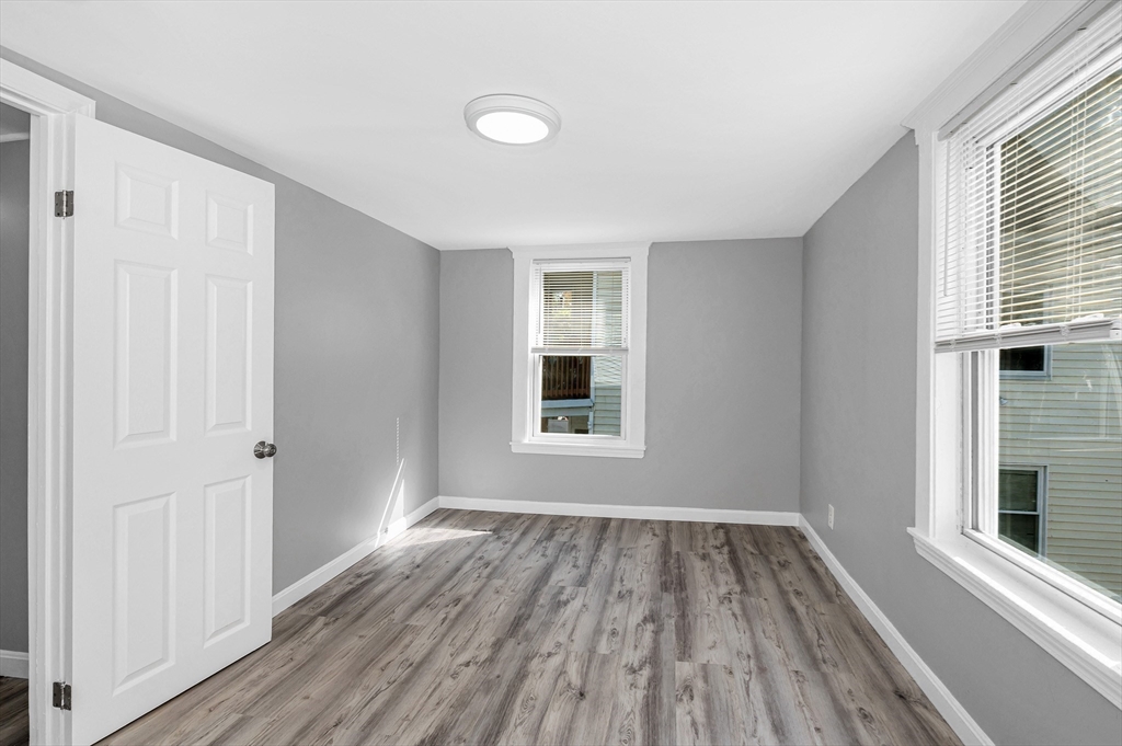 213 Prospect Street Lawrence, MA 01841 - Photo 26 of 33 a view of a room with wooden floor and window