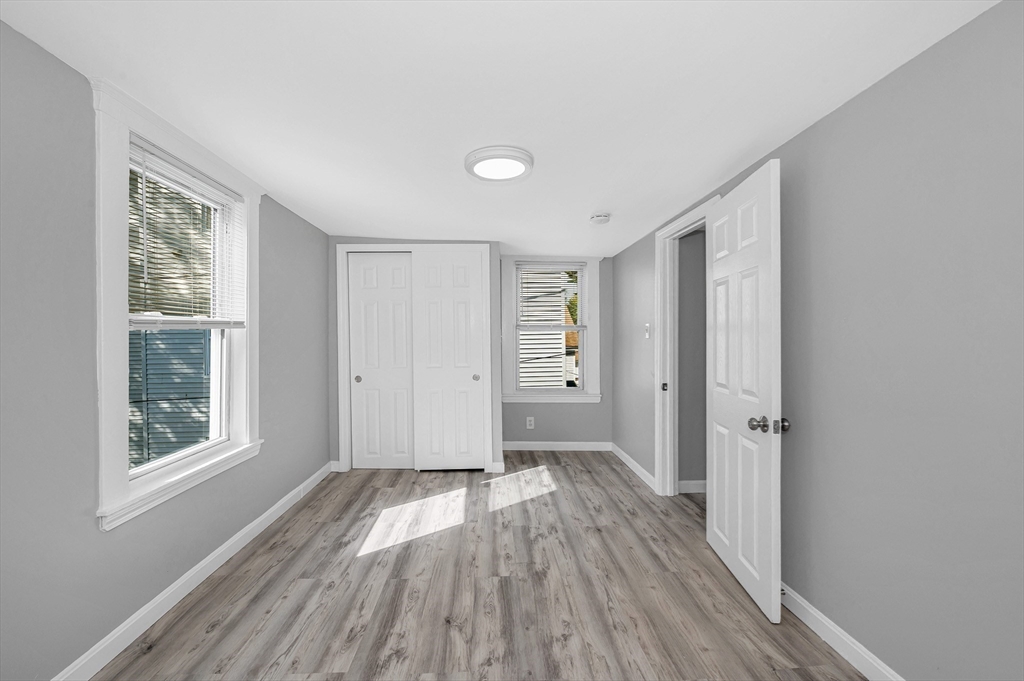 213 Prospect Street Lawrence, MA 01841 - Photo 27 of 33 wooden floor in an empty room with a window
