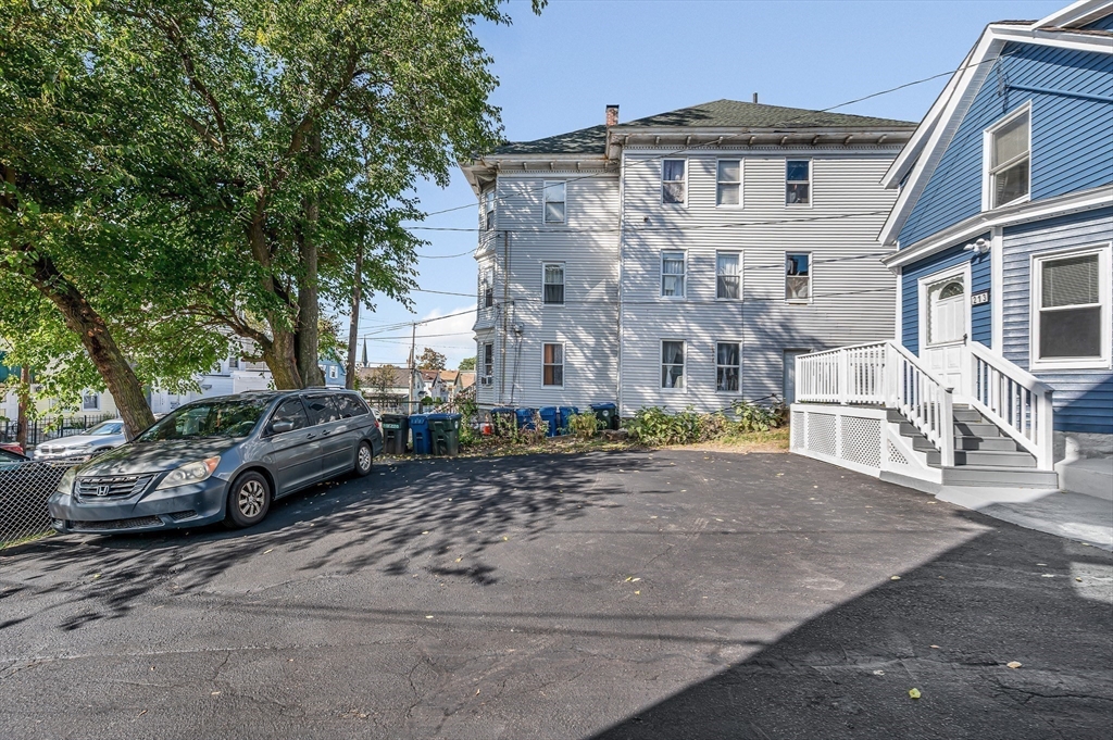 213 Prospect Street Lawrence, MA 01841 - Photo 3 of 33 a car parked in front of a white house