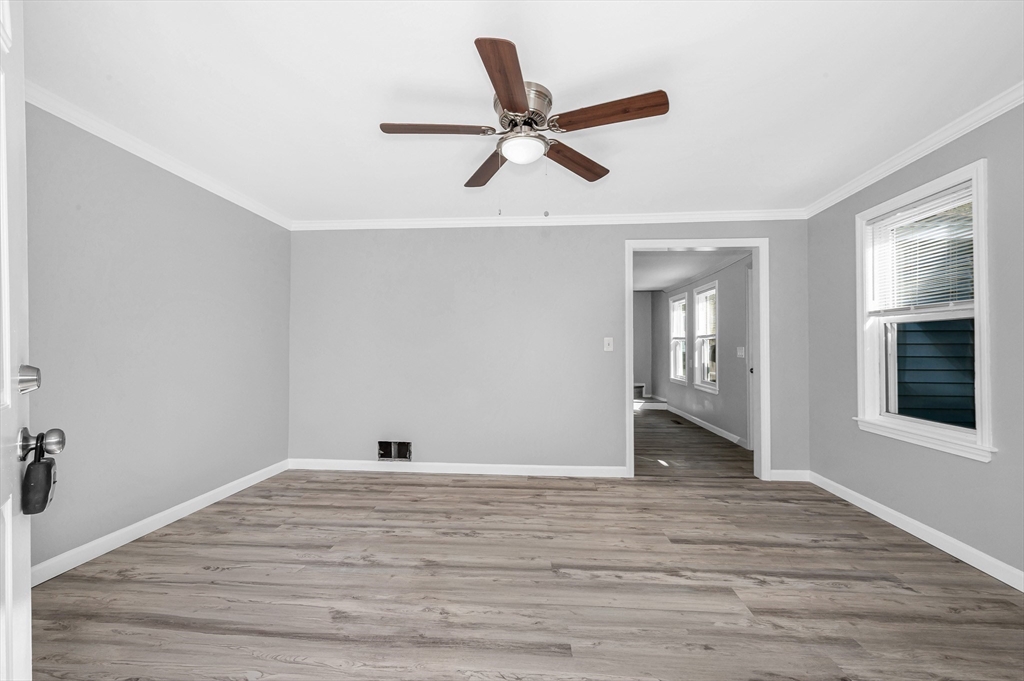213 Prospect Street Lawrence, MA 01841 - Photo 5 of 33 a view of empty room with wooden floor and ceiling fan