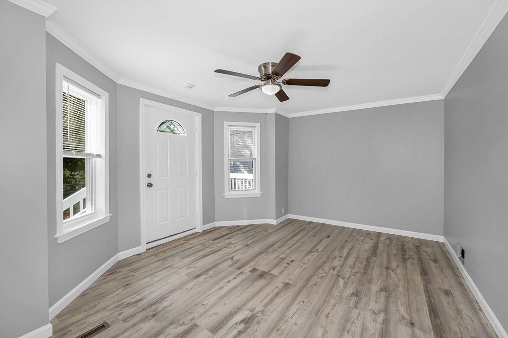 213 Prospect Street Lawrence, MA 01841 - Photo 6 of 33 a view of empty room with wooden floor and fan