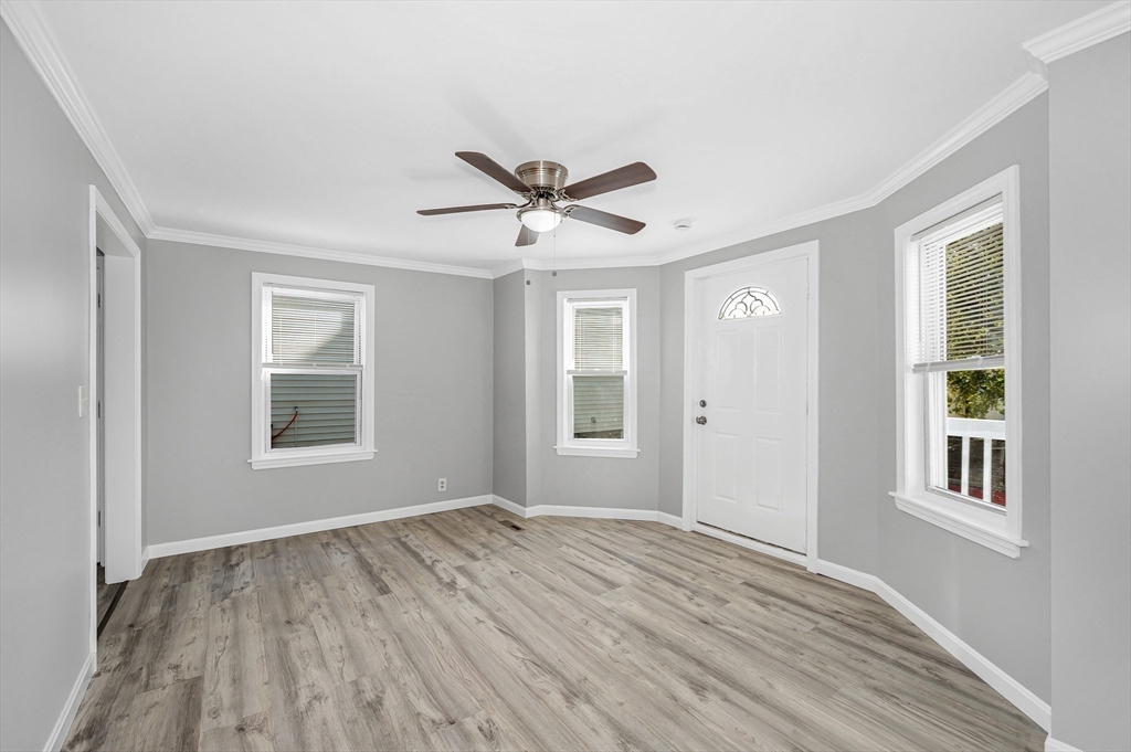 213 Prospect Street Lawrence, MA 01841 - Photo 7 of 33 a view of an empty room with a window and wooden floor
