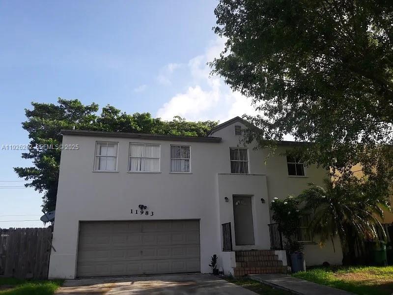 27347 Southwest 117th Place Homestead, FL 33032 - Photo 1 of 37 front view of a house with a tree
