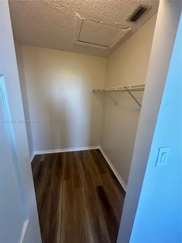 a view of closet with wooden floor