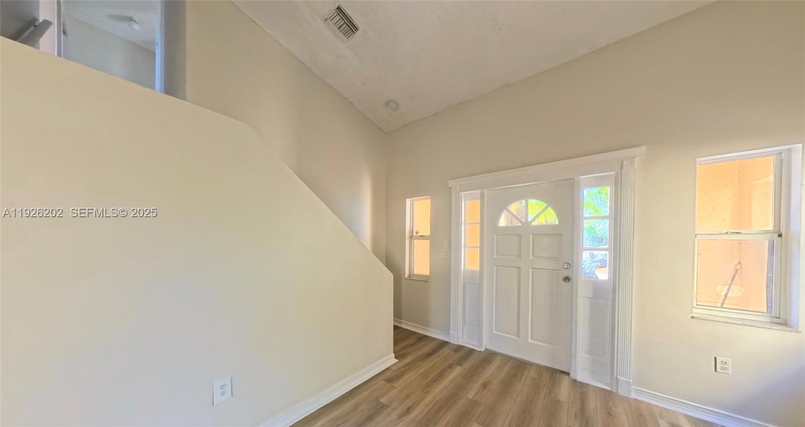 27347 Southwest 117th Place Homestead, FL 33032 - Photo 2 of 37 a view of a room with wooden floor and windows