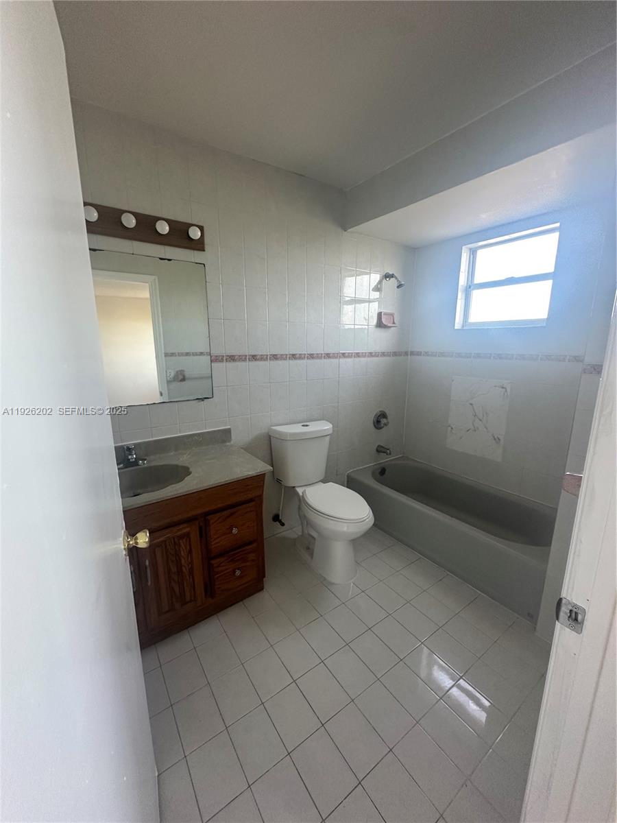 27347 Southwest 117th Place Homestead, FL 33032 - Photo 25 of 37 a bathroom with a sink a toilet and mirror
