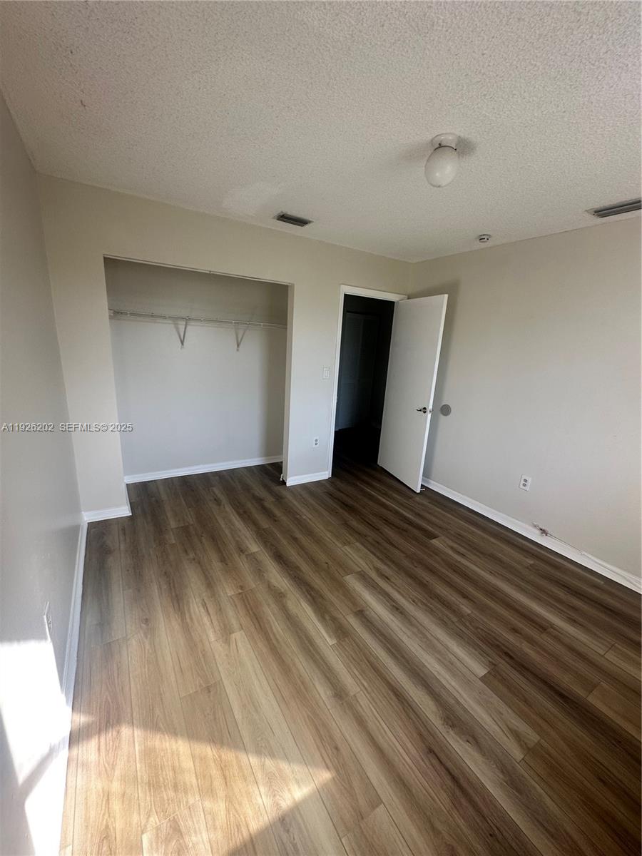 27347 Southwest 117th Place Homestead, FL 33032 - Photo 31 of 37 a view of empty room with wooden floor