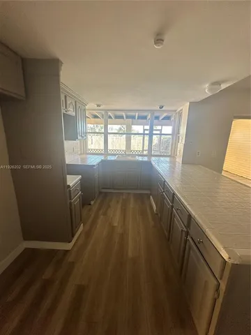 a view of wooden floor and windows in a room
