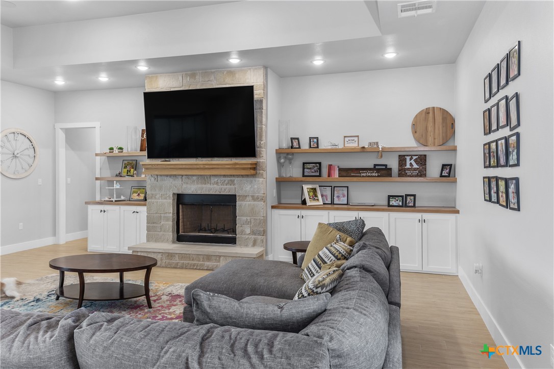 13428 Knob Hill Road Rogers, TX 76569 - Photo 11 of 41 a living room with furniture a flat screen tv and a fireplace
