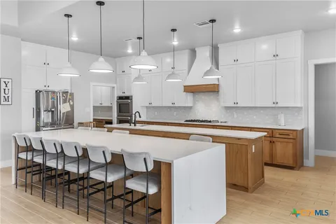 a large kitchen with lots of counter space and a sink