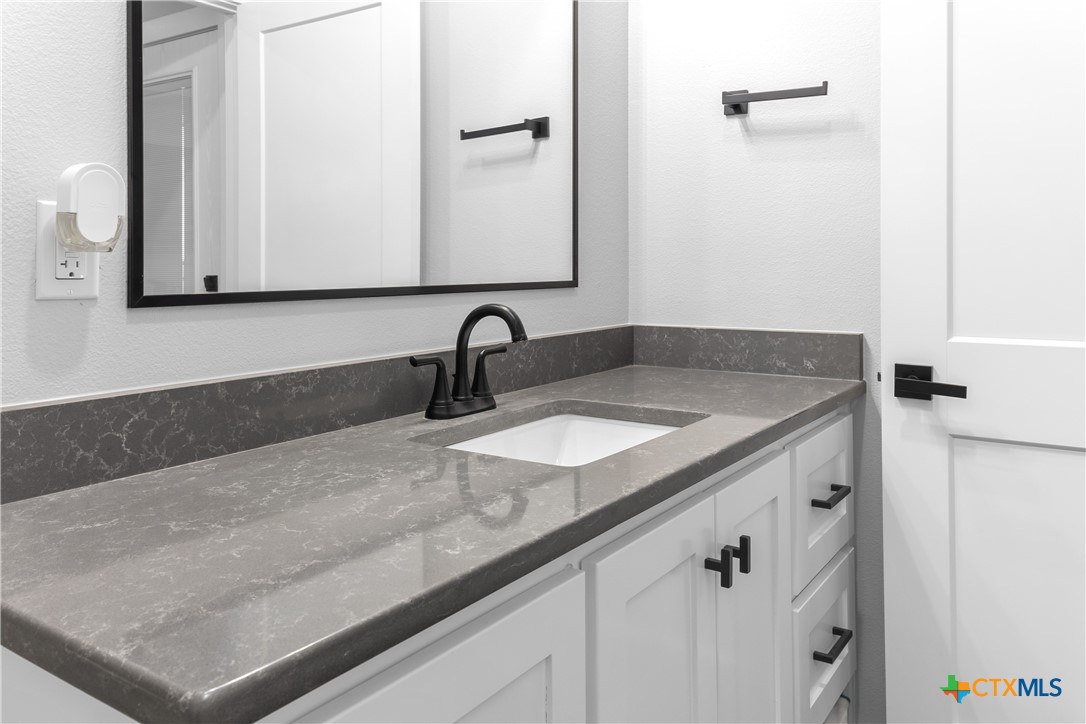 13428 Knob Hill Road Rogers, TX 76569 - Photo 25 of 41 a bathroom with a sink and a mirror