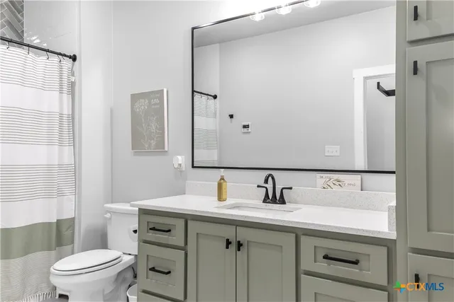 a view of an empty room with closet and wooden floor