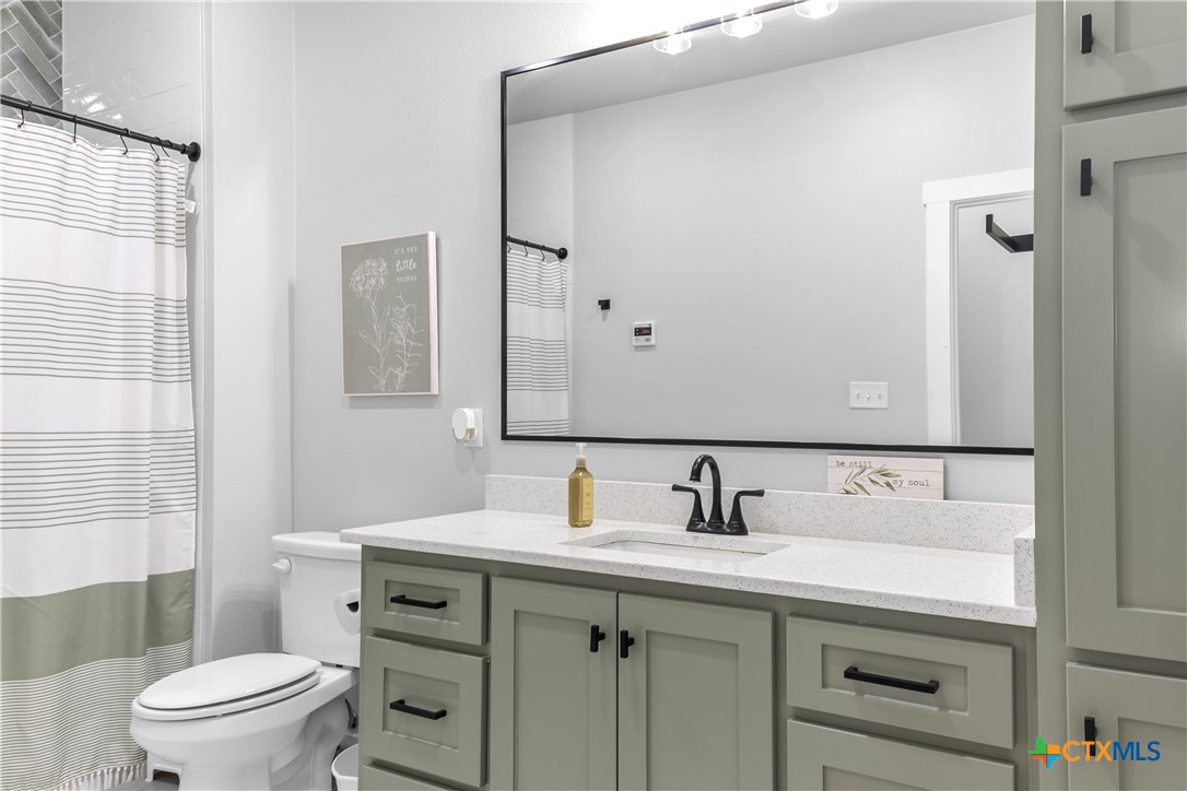 13428 Knob Hill Road Rogers, TX 76569 - Photo 29 of 41 a bathroom with a sink toilet and shower