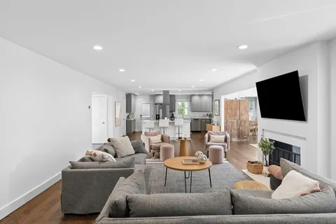a living room with fireplace furniture and a flat screen tv