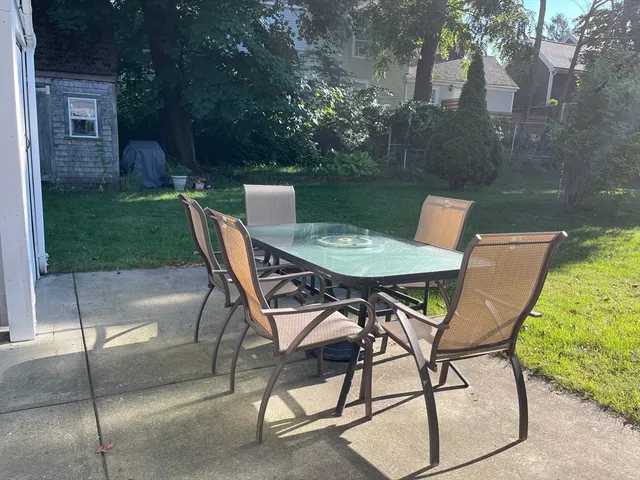a patio with table and chairs