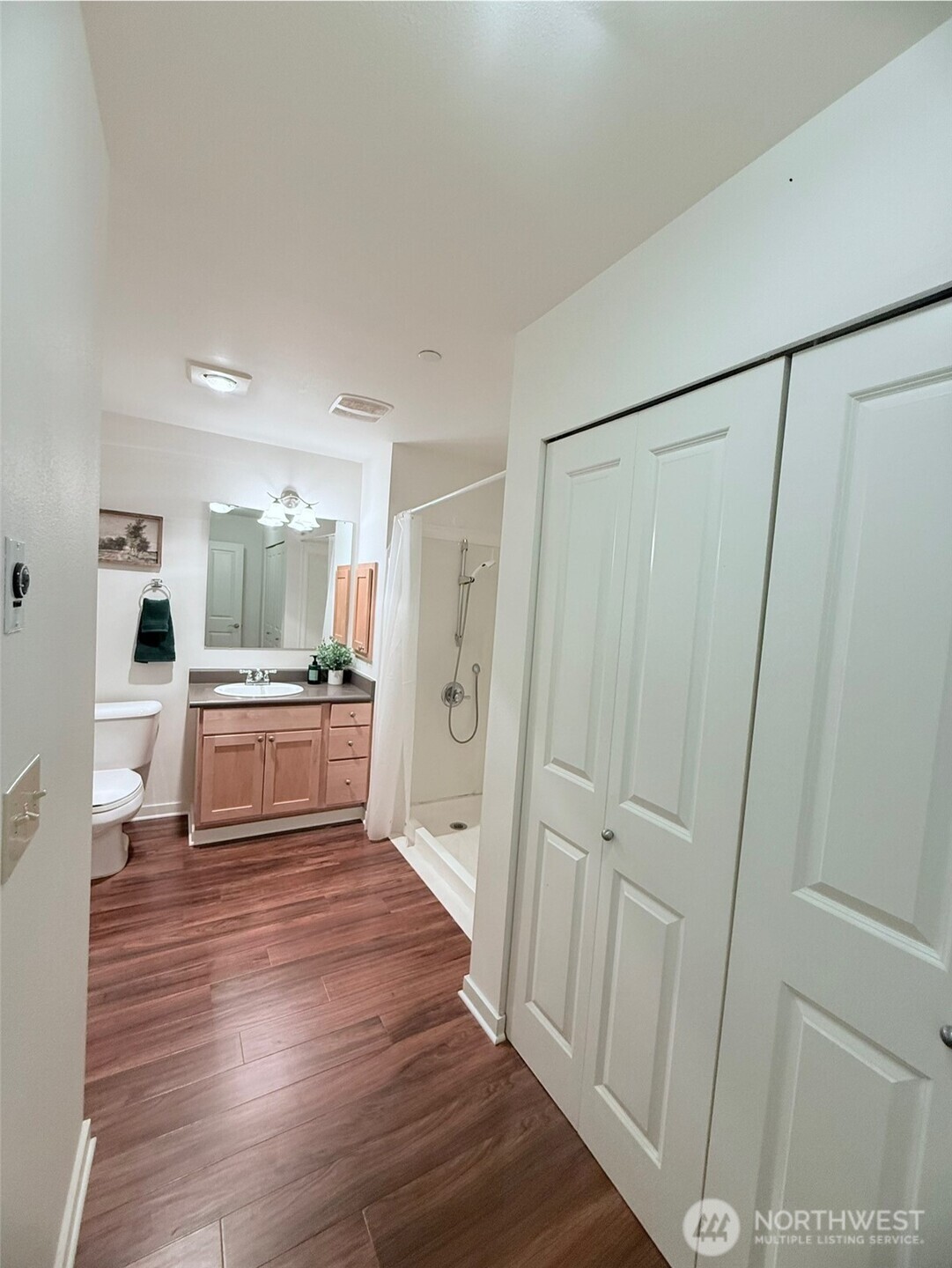 300 High School Road Northeast, Unit 203 Bainbridge Island, WA 98110 - Photo 11 of 13 a view of a kitchen with white cabinets and white appliances
