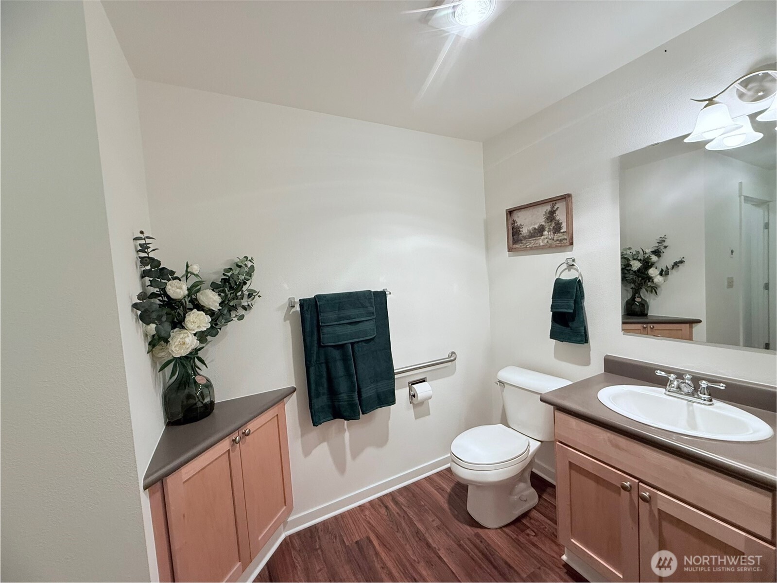 300 High School Road Northeast, Unit 203 Bainbridge Island, WA 98110 - Photo 12 of 13 a bathroom with a toilet a sink and mirror
