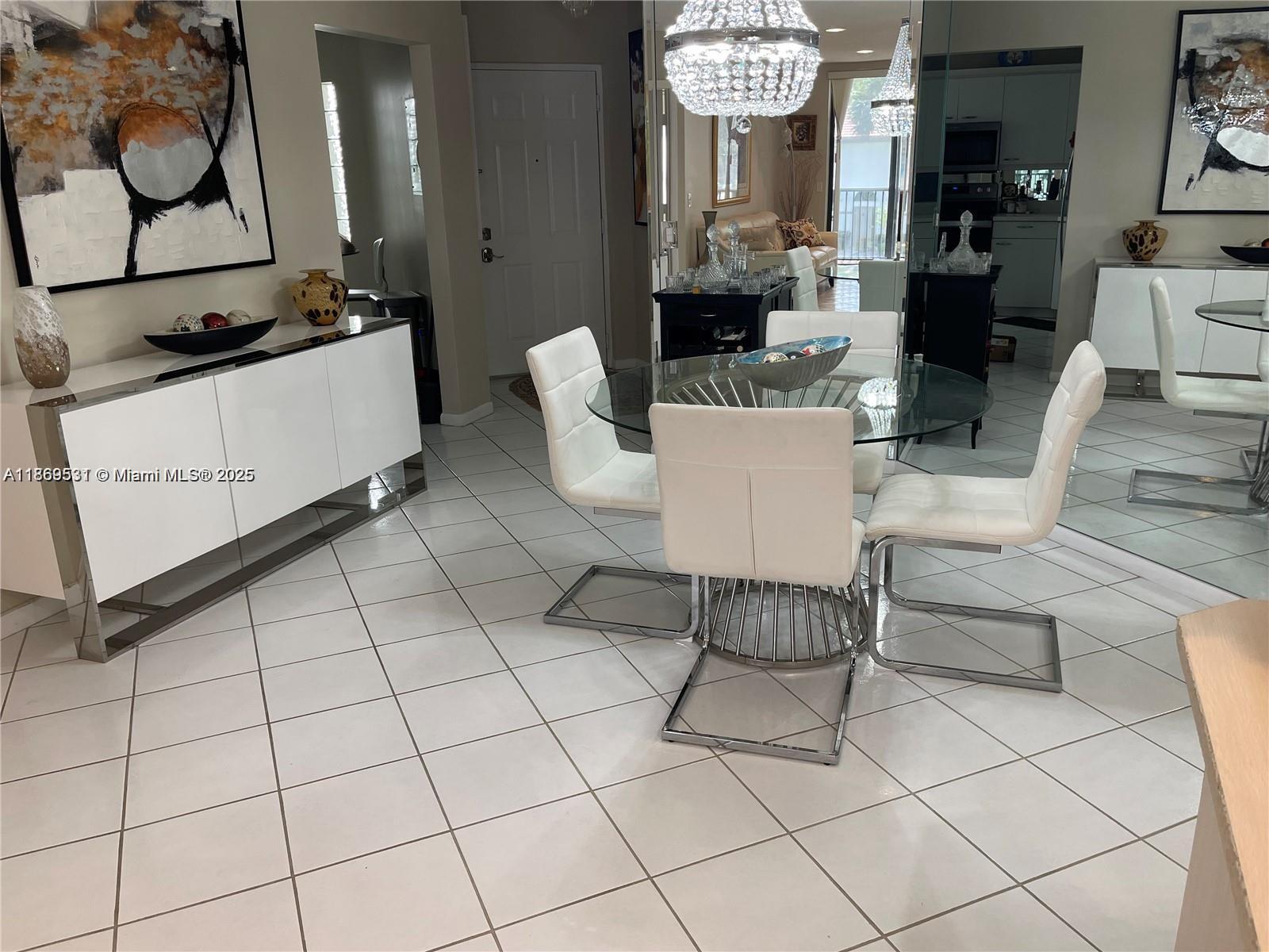 5133 Brisata Circle, Unit L Boynton Beach, FL 33437 - Photo 12 of 42 a living room with furniture a chandelier and a rug