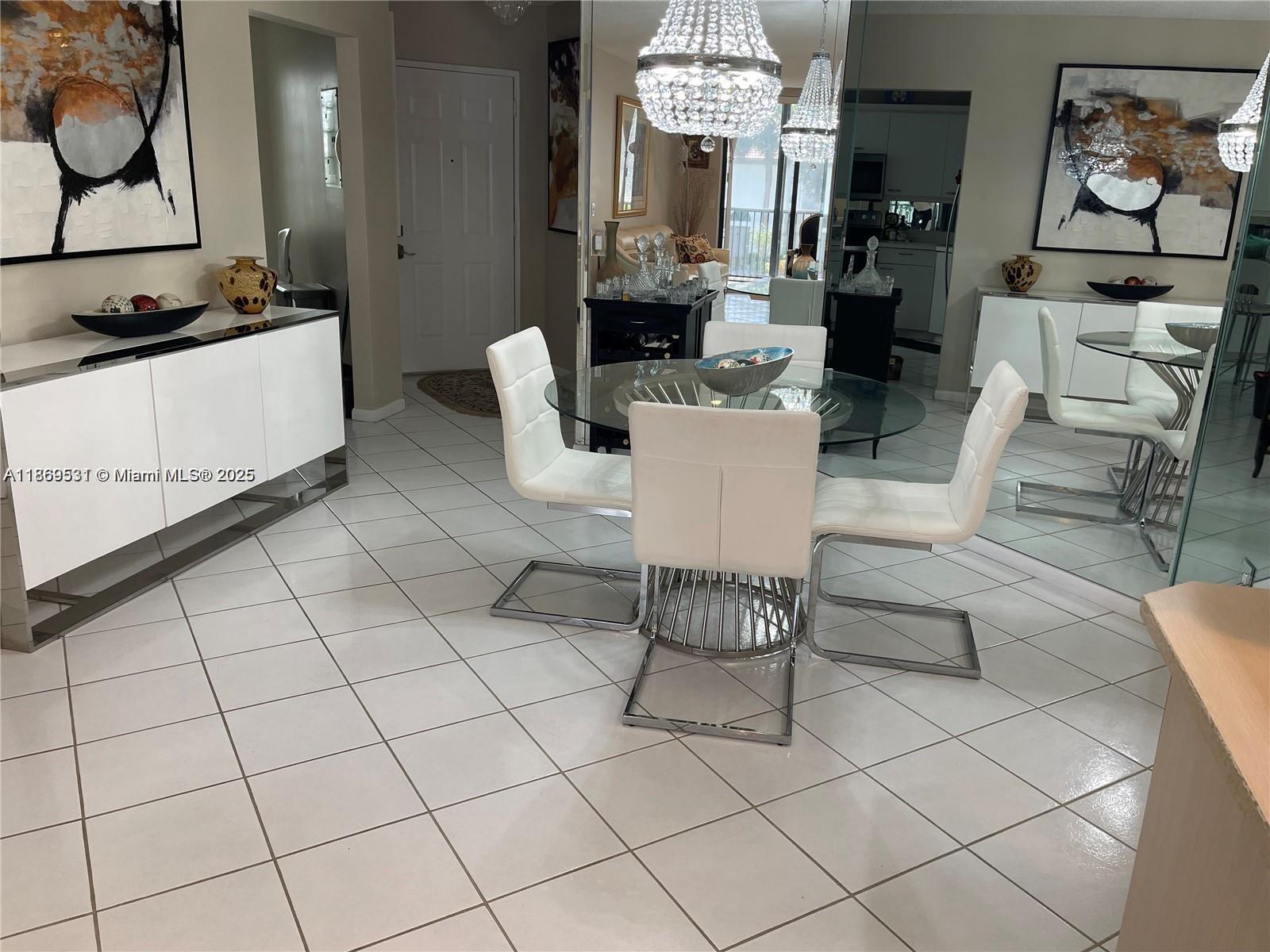 5133 Brisata Circle, Unit L Boynton Beach, FL 33437 - Photo 14 of 42 a living room with furniture a chandelier and a fireplace