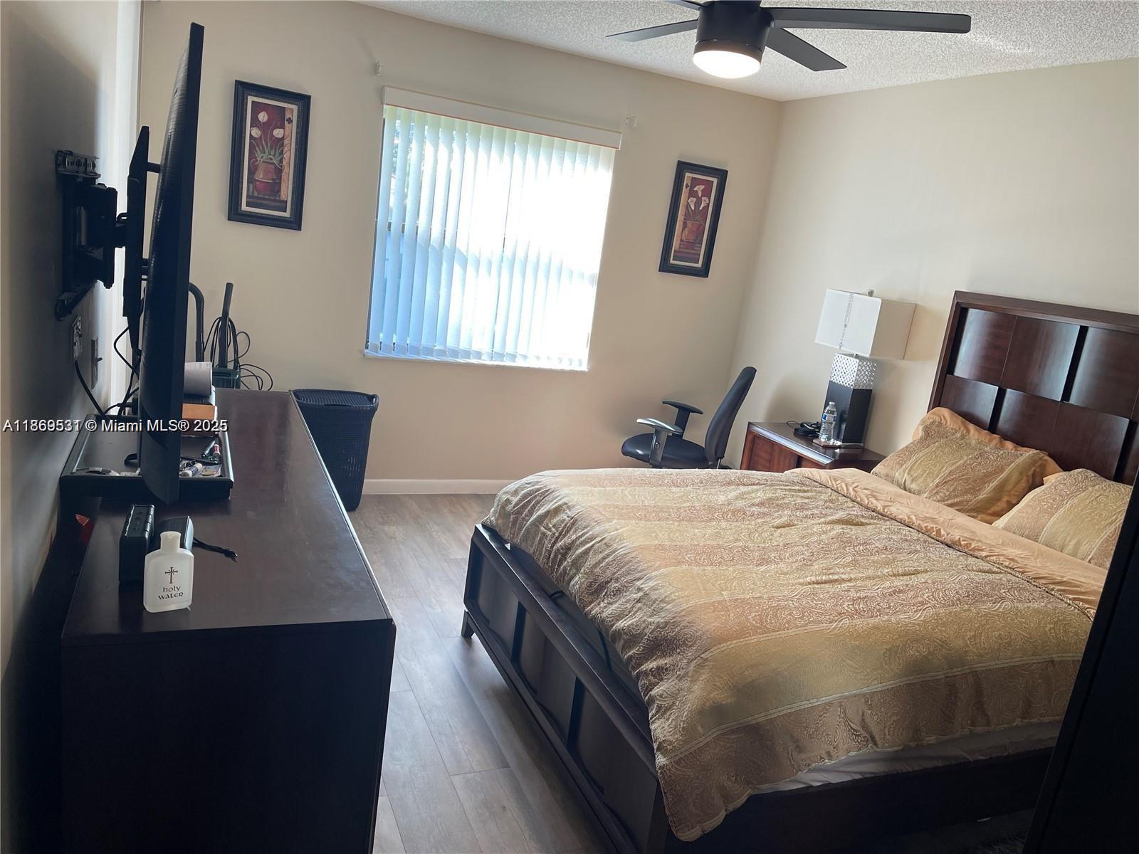 5133 Brisata Circle, Unit L Boynton Beach, FL 33437 - Photo 19 of 42 a bed sitting in a bedroom next to a window