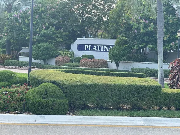 a view of a park that has a sign board