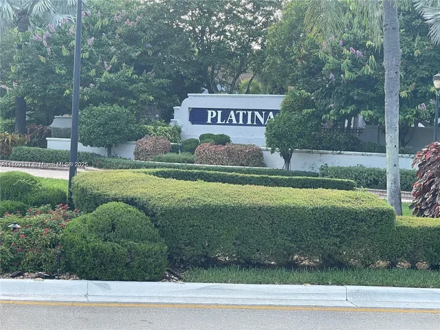 a view of a park that has a sign board