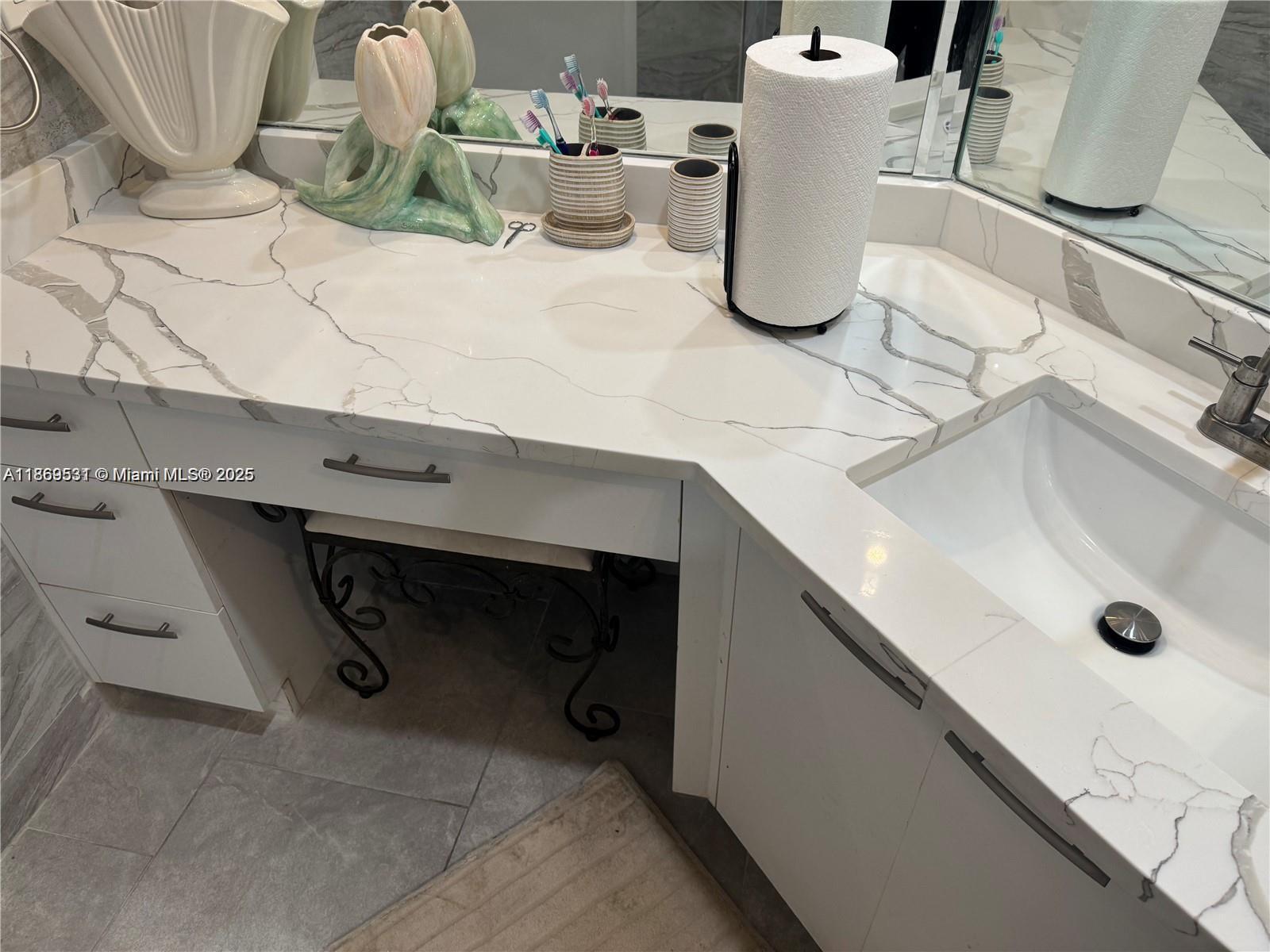 5133 Brisata Circle, Unit L Boynton Beach, FL 33437 - Photo 22 of 42 a bathroom with a sink and a mirror