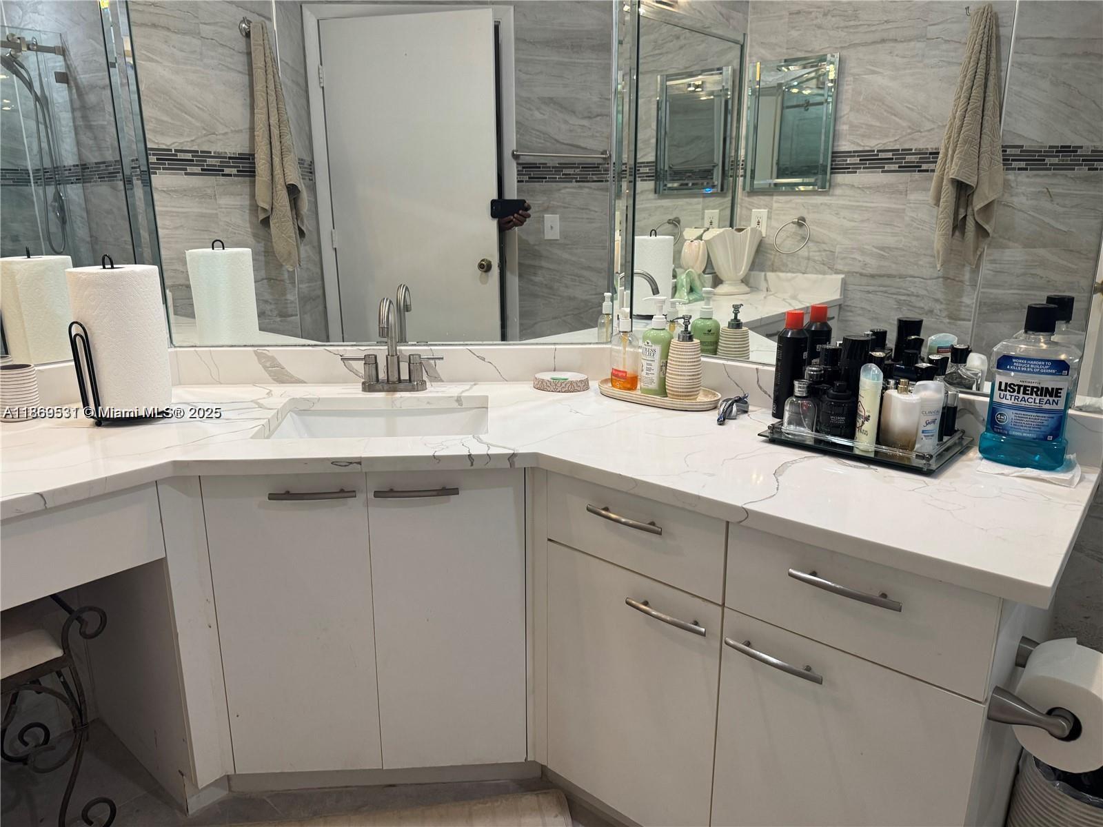 5133 Brisata Circle, Unit L Boynton Beach, FL 33437 - Photo 23 of 42 a bathroom with a sink and a mirror