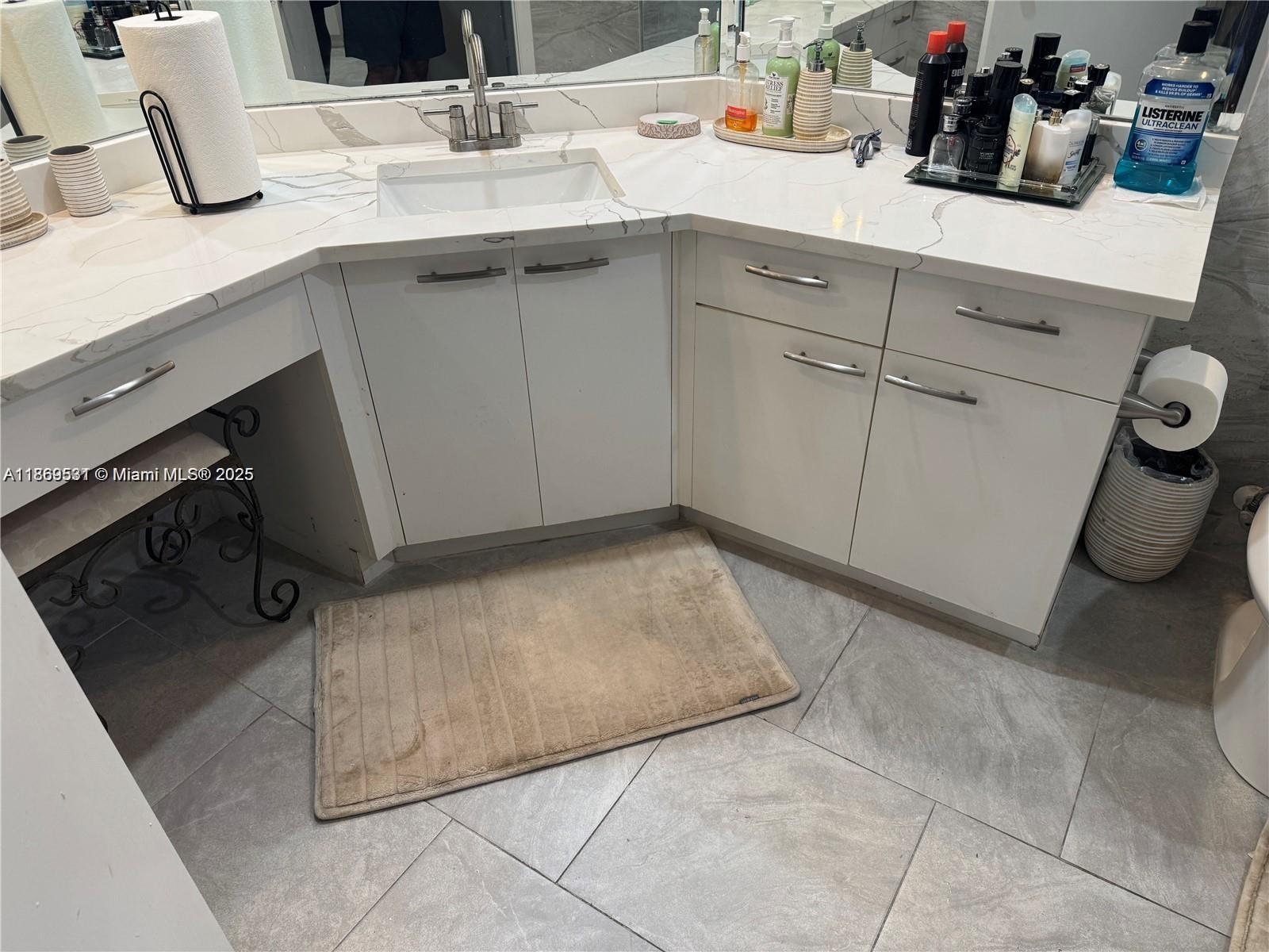 5133 Brisata Circle, Unit L Boynton Beach, FL 33437 - Photo 24 of 42 a kitchen with a sink and cabinets