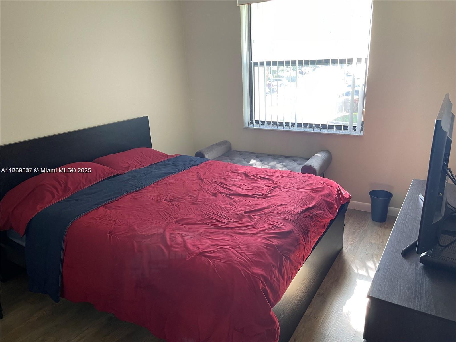 5133 Brisata Circle, Unit L Boynton Beach, FL 33437 - Photo 28 of 42 a bedroom with a bed and a window