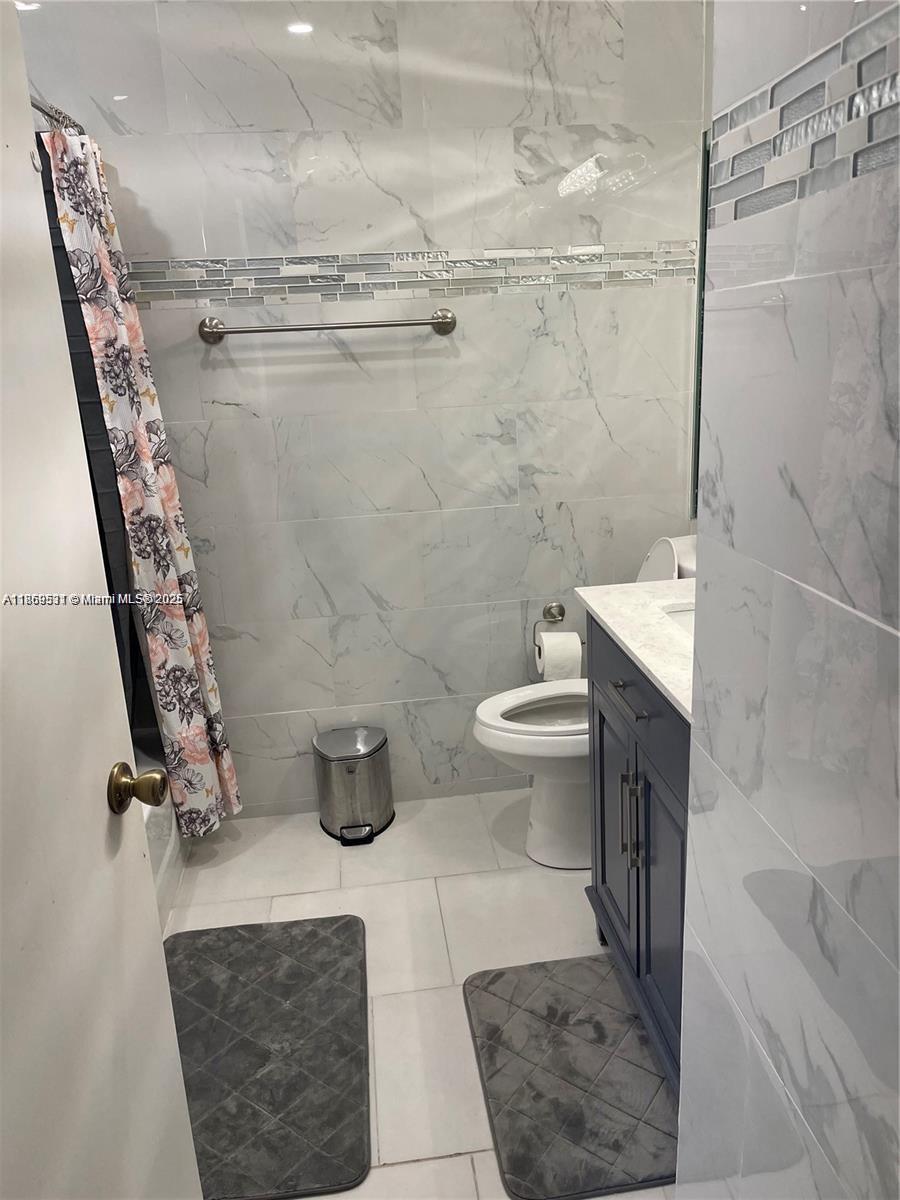 5133 Brisata Circle, Unit L Boynton Beach, FL 33437 - Photo 29 of 42 a bathroom with a toilet and a shower