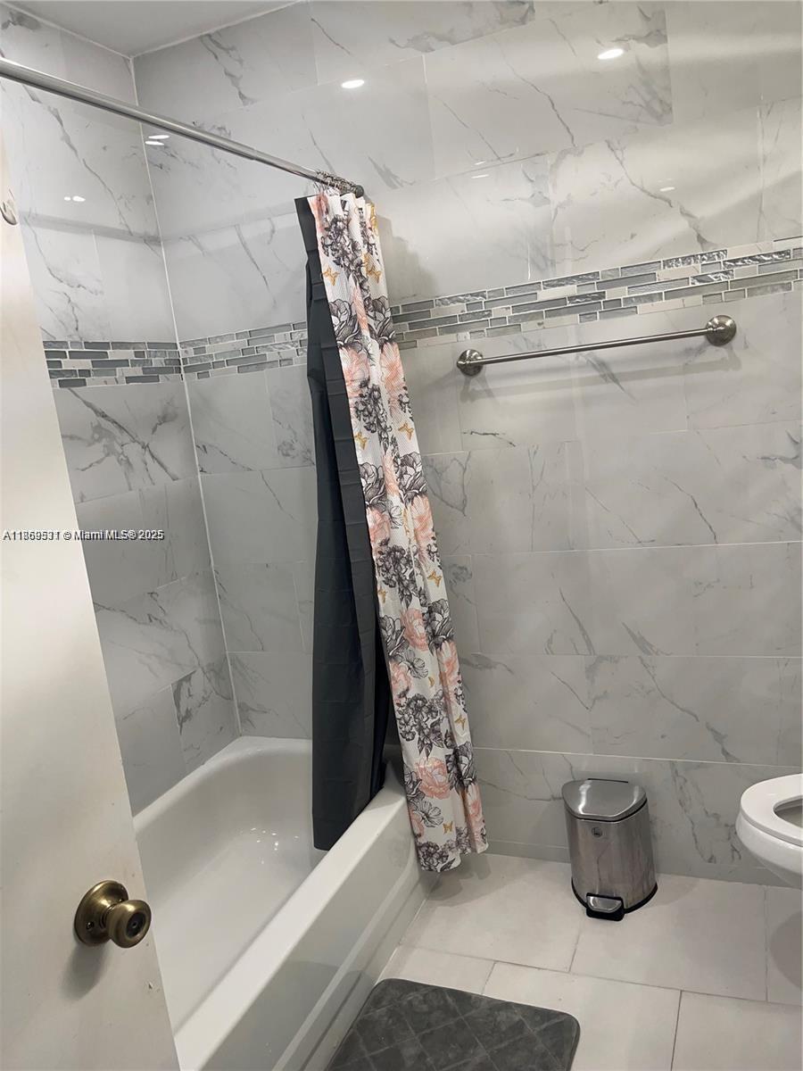5133 Brisata Circle, Unit L Boynton Beach, FL 33437 - Photo 30 of 42 a bathroom with a shower and a toilet