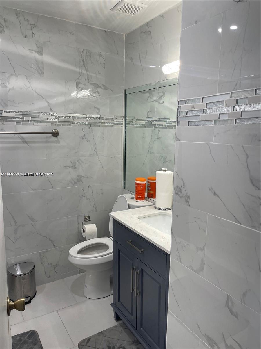 5133 Brisata Circle, Unit L Boynton Beach, FL 33437 - Photo 31 of 42 a bathroom with a sink a toilet and a shower