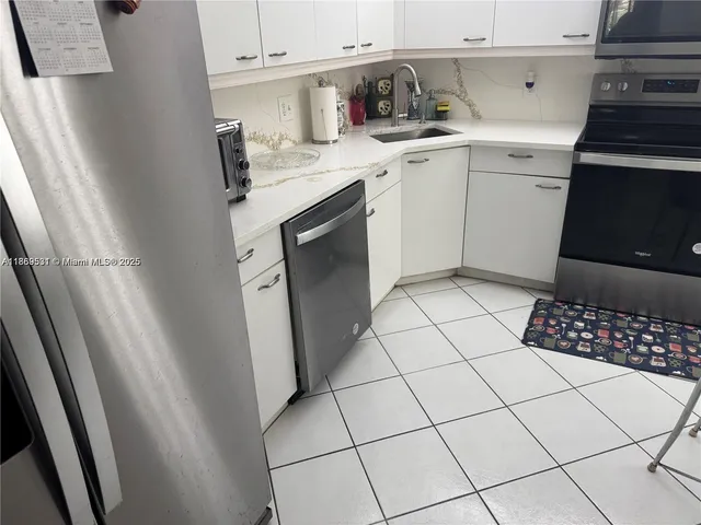 a living room with furniture a chandelier and a rug