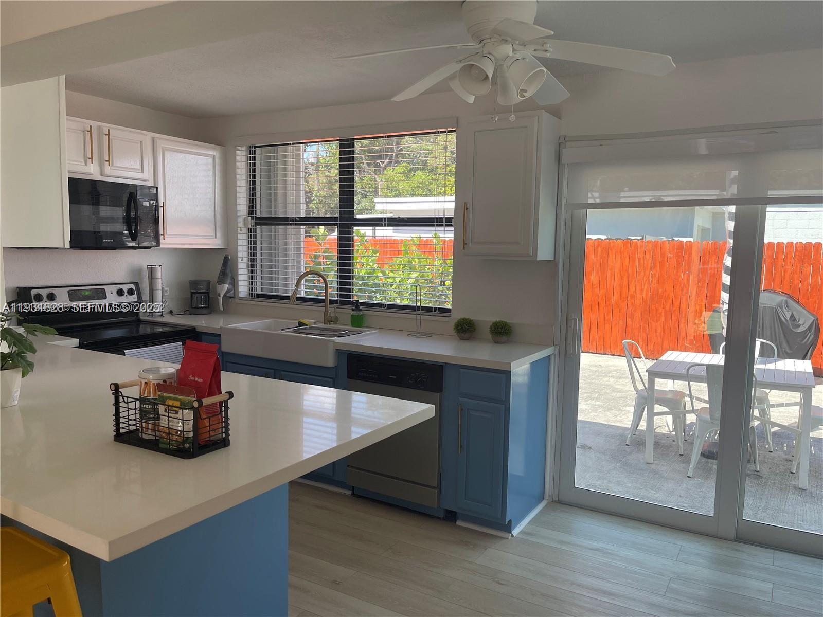 1560 Northeast 145th Street, Unit 1 Miami, FL 33161 - Photo 3 of 11 a kitchen with stainless steel appliances granite countertop a stove and a sink