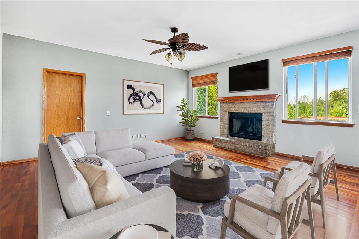2172 Prairie Trail Round Lake Heights, IL 60073 - Photo 4 of 28 a living room with furniture a fireplace and a flat screen tv