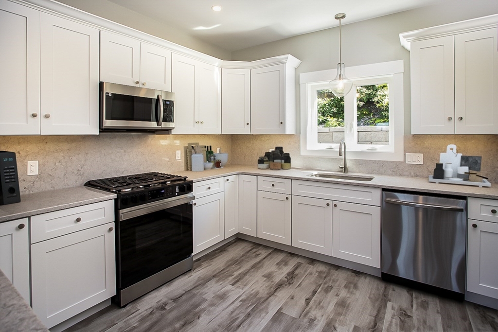 337 Danforth Street, Unit 7 Fall River, MA 02720 - Photo 12 of 28 a kitchen with stainless steel appliances white cabinets a sink and a stove