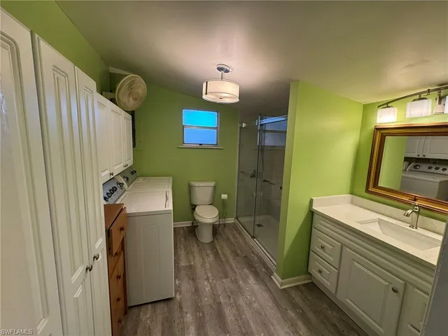 a bathroom with a sink a toilet and mirror
