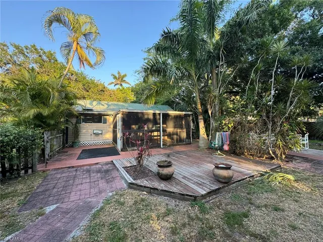 a porch with wooden floors and outdoor seating