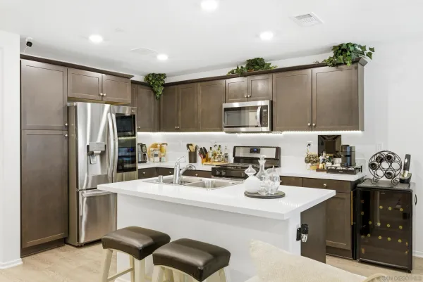 a kitchen with a refrigerator and a sink