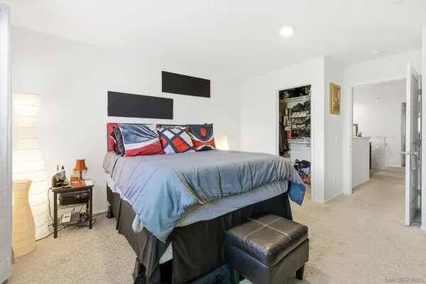 a bedroom with a bed and a television